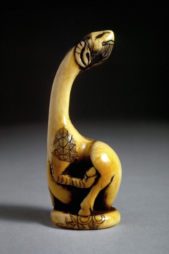 Carving of a mythical animal with a long neck.