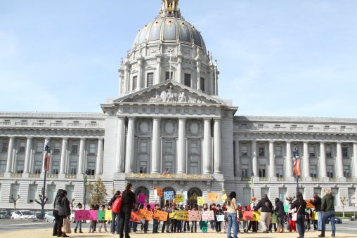 Children holding posters outside San Francisco City Hall.