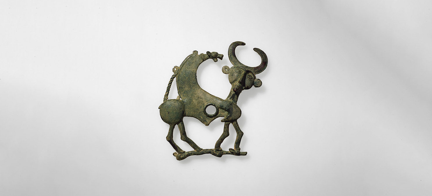 Metal object showing a mythical creature.