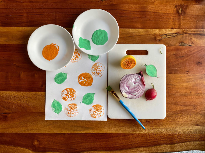 Detail view of painted vegetable stamp activity.